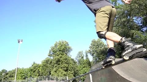 Young man is rollerblading in the park. Close-up of sliding through a pipe. 스톡 동영상 140050962
