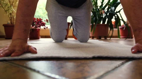 Young man rolling up his mat for sport training Stock Footage 201195846