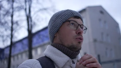 Young man rubbing hands together warming up outside Stock Footage 293477833