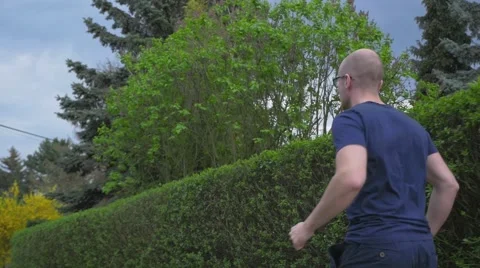 Young man runing in the park and checking up his phone. He is late. Video stock 62519934