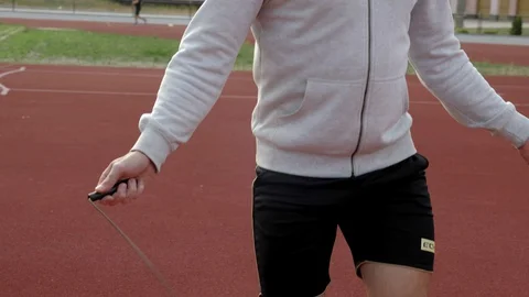 Young man runner workout with jumping rope Stock Footage 130138577