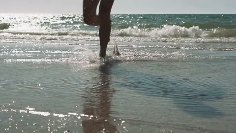 Young man running and diving into the wavy sea., slow motion. Stock Footage 91277882