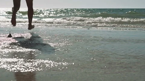 Young man running and diving into the wavy sea., slow motion. Stock Footage 91277903
