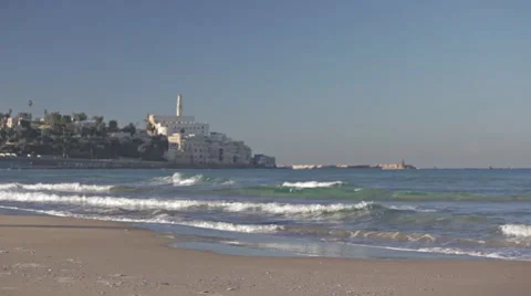 Young man running on the beach with a castle on the backgroung. Original Stock Footage 57973193