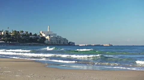 Young man running on the beach with a castle on the backgroung. Color grading 스톡 동영상 57974256