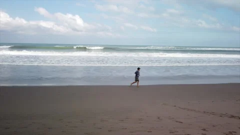 Young man running on the beach. Indian Ocean. Stock Footage 159593149