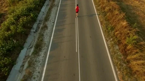 Young Man Running On a Beautiful Sunset Drone View Stock Footage 68884082