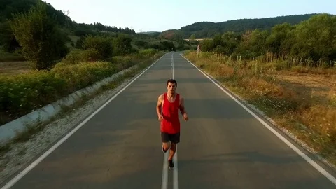 Young Man Running On a Beautiful Sunset Drone View Stock Footage 69718847