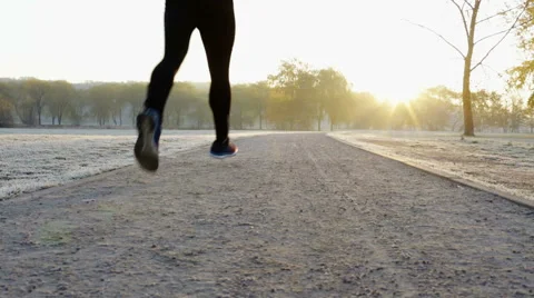Young man running at cold winter morning in park Stock Footage 57819925