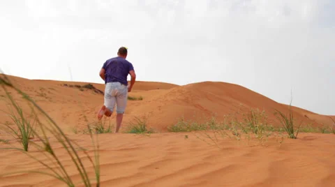 Young man running in the desert Stock Footage 36115583