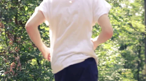 Young man running down nature track Stock Footage 41098223