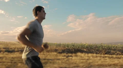 Young Man Running in the Field Stock Footage 55832190