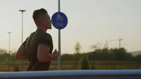 Young man running Stock Footage 100033614