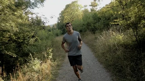 Young Man Running in the Forest Stock Footage 55832463