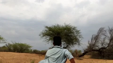 A young man running in the forest with monsoon cloudscape background Stock Footage 157616570