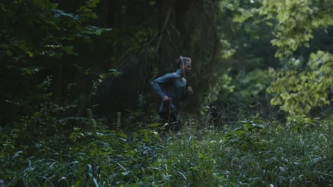Young man running-jogging in forest Stock Footage 90739773