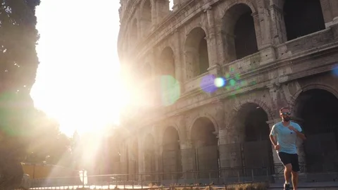 Young man running jogging in front of Colosseum at sunrise. Rome, Italy. Stock Footage 117355930