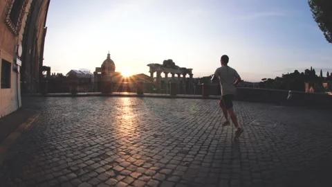 Young man running jogging in front of the Roman Forum at sunrise. Historical Stock Footage 238477867