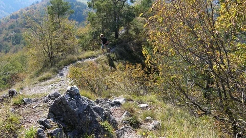 Young man running up a mountain trail Stock Footage 112388696