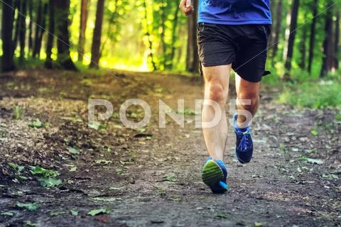 Young man running outdoors in the morning. Stock Photos