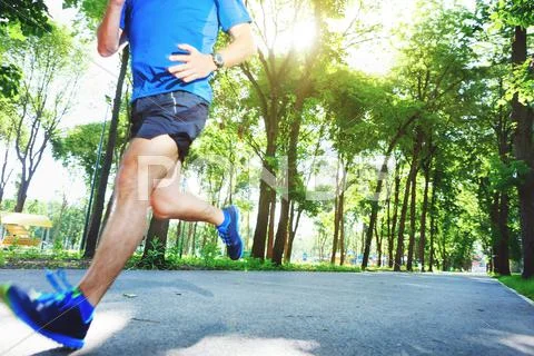 Young man running outdoors in the morning. Stock Photos