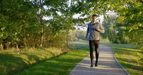 Young man running in park – checking his smartphone and run away Video stock 55327525