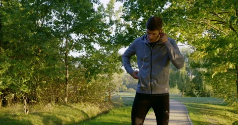 Young man running in park – checking message on the phone and run away Stock Footage 55327538