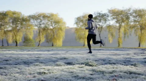 Young man running in park, during cold autumn morning Stock Footage 57818710