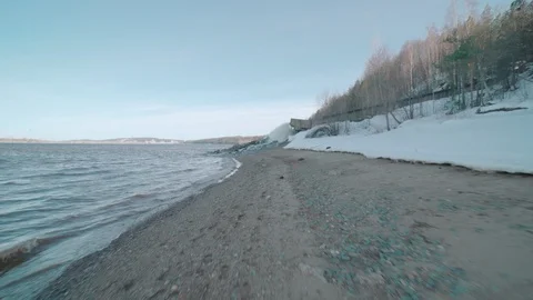Young man running on river coast Stock Footage 106441772