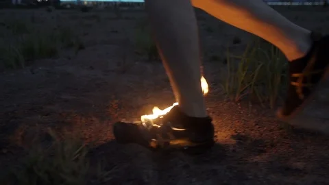 Young man running on sand in burning boot at coast Slow motion Stock Footage 95909084