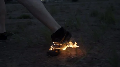 Young man running on sand in burning boot on field Slow motion Stock Footage 95909114