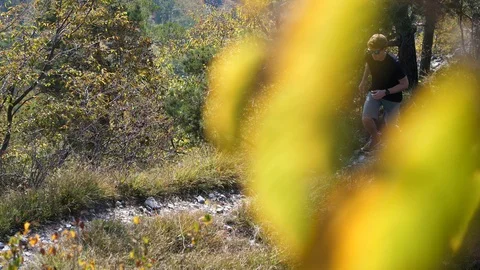 Young man running toward camera on a mountain trail Stock Footage 112388674
