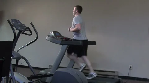Young man running on a treadmill Stock Footage 49862967
