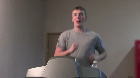 Young man running on a treadmill. medium shot. Video stock 49862945