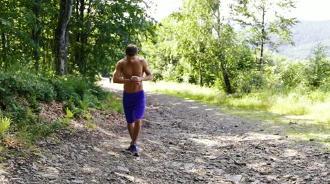 Young man running uphill, having short breake Stock Footage 55865931