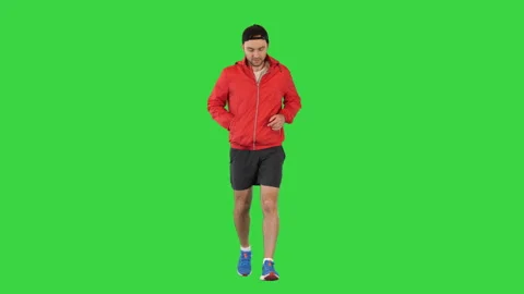 Young man running in a windbreaker on a Green Screen, Chroma Key. Stock-Footage 156187853
