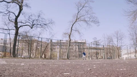 Young man runs up to camera, reverses and runs back. Training at city park Stock Footage 76046013