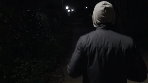 A young man runs in the night Stock Footage 101973192