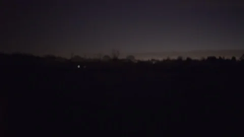 A young man runs in a park during sunset in silhouette, side tracking shot Stock Footage 101889705