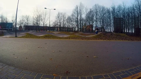 Young man runs through playground. It seems to be early dark morning. Stock Footage 115500812