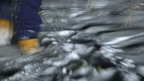 A young man runs through the snow at night in the woods. Video stock 100203014