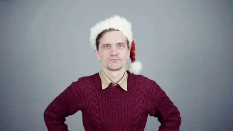 Young man in Santa hat opening a gift box with a surprise inside seeing coffee Stock Footage 70261036