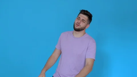 Young man saying no shaking head and hand gestures isolated on blue background Stock Footage 123947736
