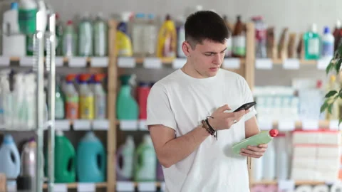 Young man scanning qr code for dishwashing Stock Footage 309539220