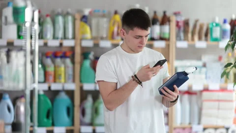 Young man scanning qr code for cleaning spray Stock Footage 310963979