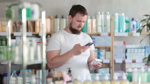 Young man scanning qr code of paracetamol Stock Footage 313097976