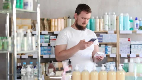 Young man scanning qr code of paracetamol Stock Footage 329394542