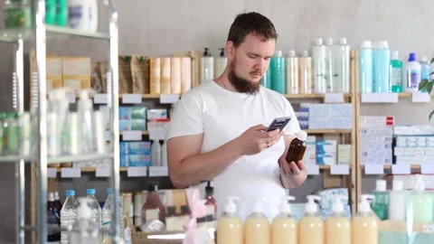 Young man scanning qr code of syrup Stock Footage 329541424