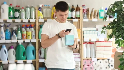 Young man scanning qr code for feminine pads Stock Footage 330039108