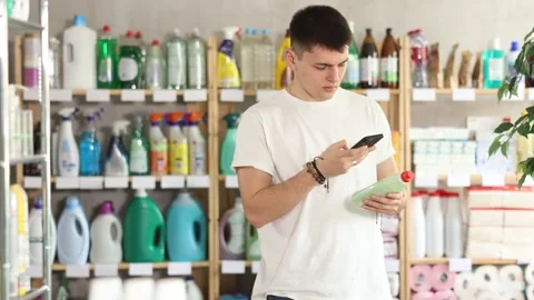 Young man scanning qr code for dishwashing Stock Footage 332636017